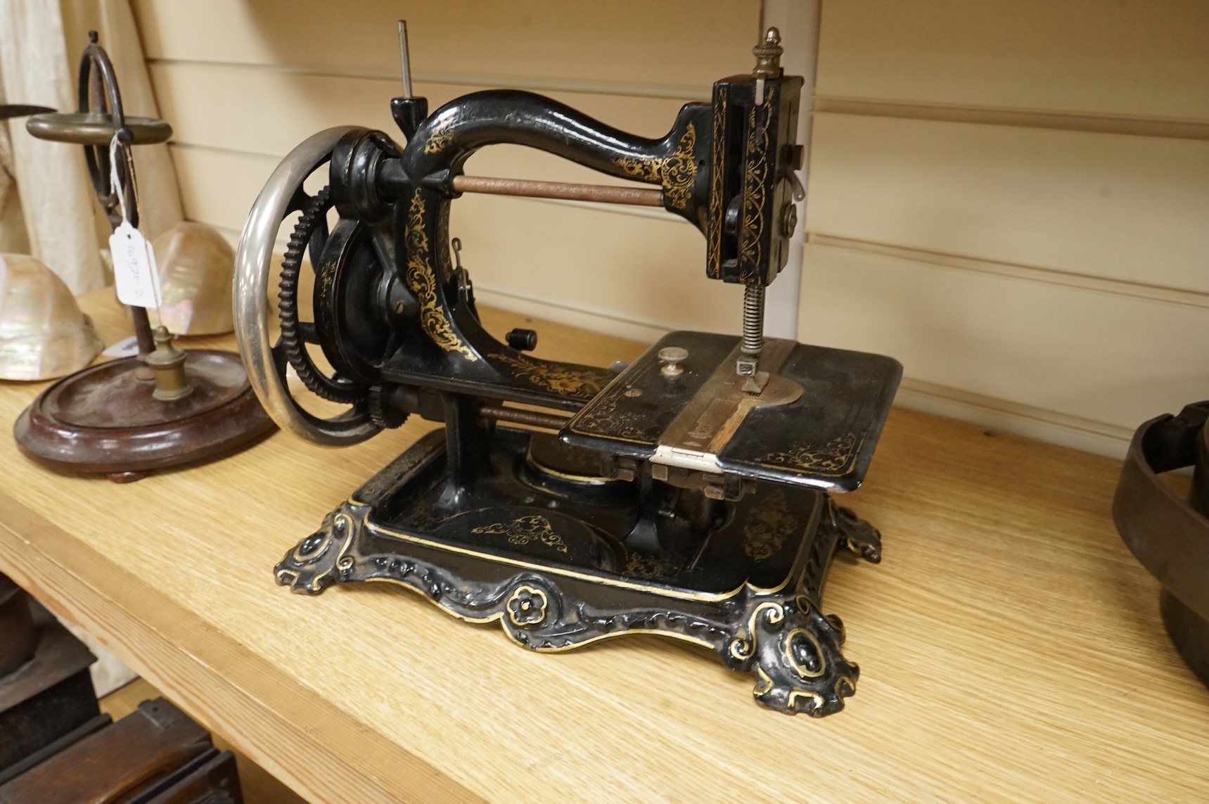 A late 19th century Wanzer sewing machine, in black enamel with gilt decoration.